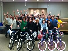 A team with the bicycles they built for a children's charity