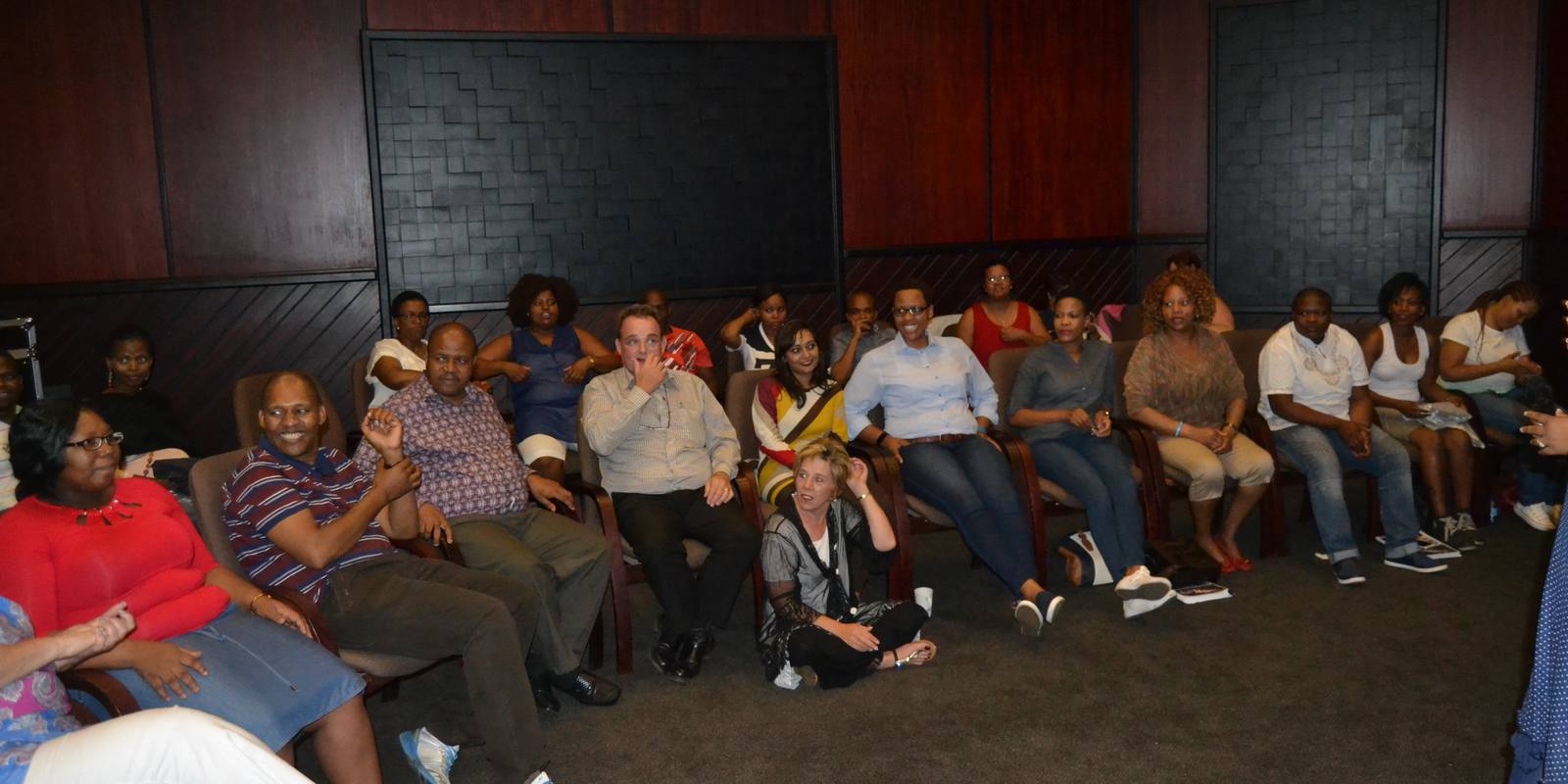 A group seated in a circle for the facilitated debrief
