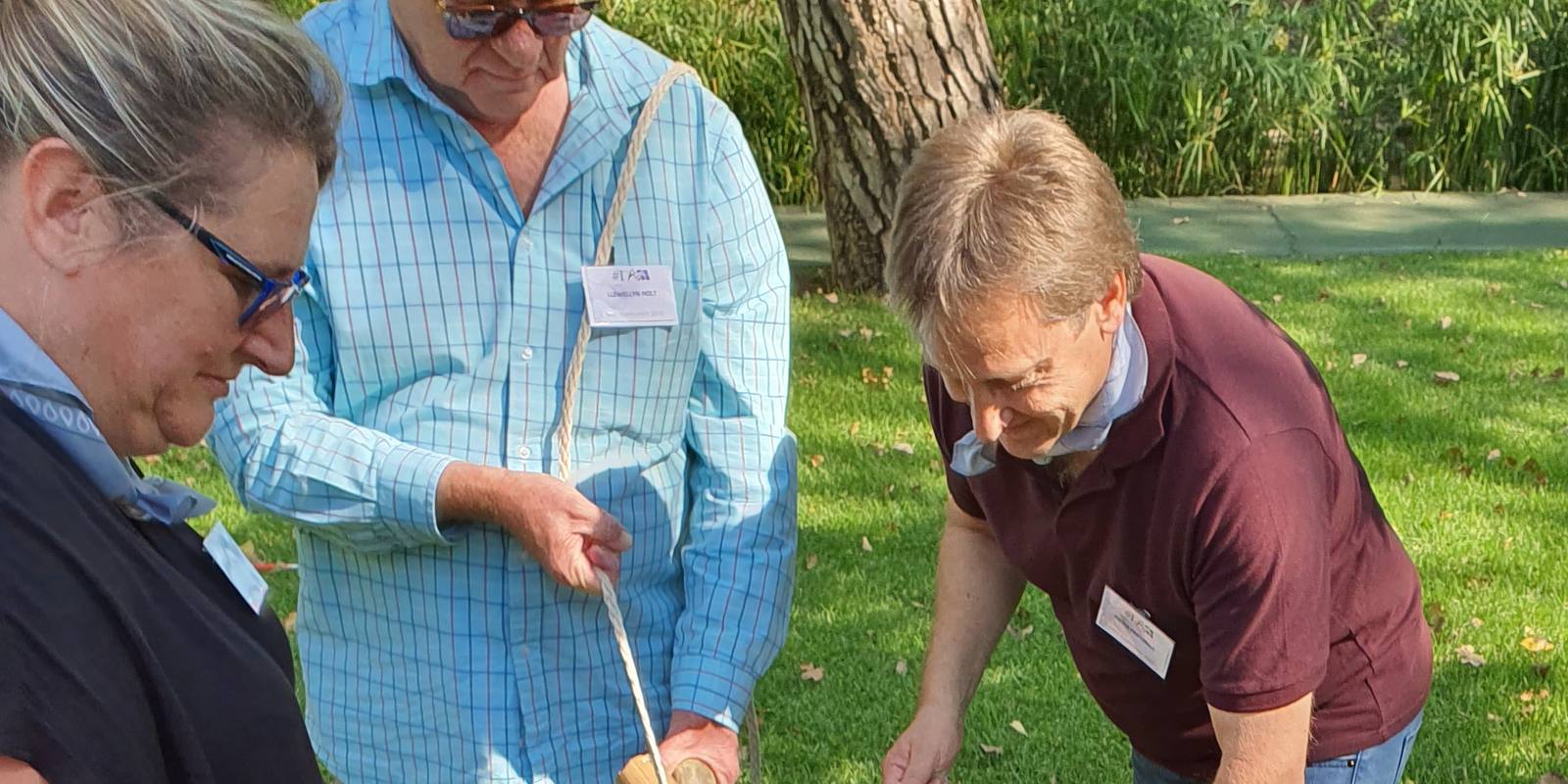 Managers concentrating as they lash a structure together