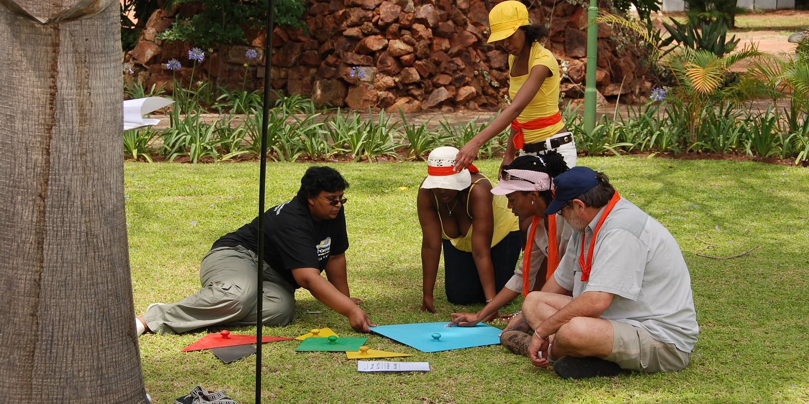 A small team working through a challenge on the lawn