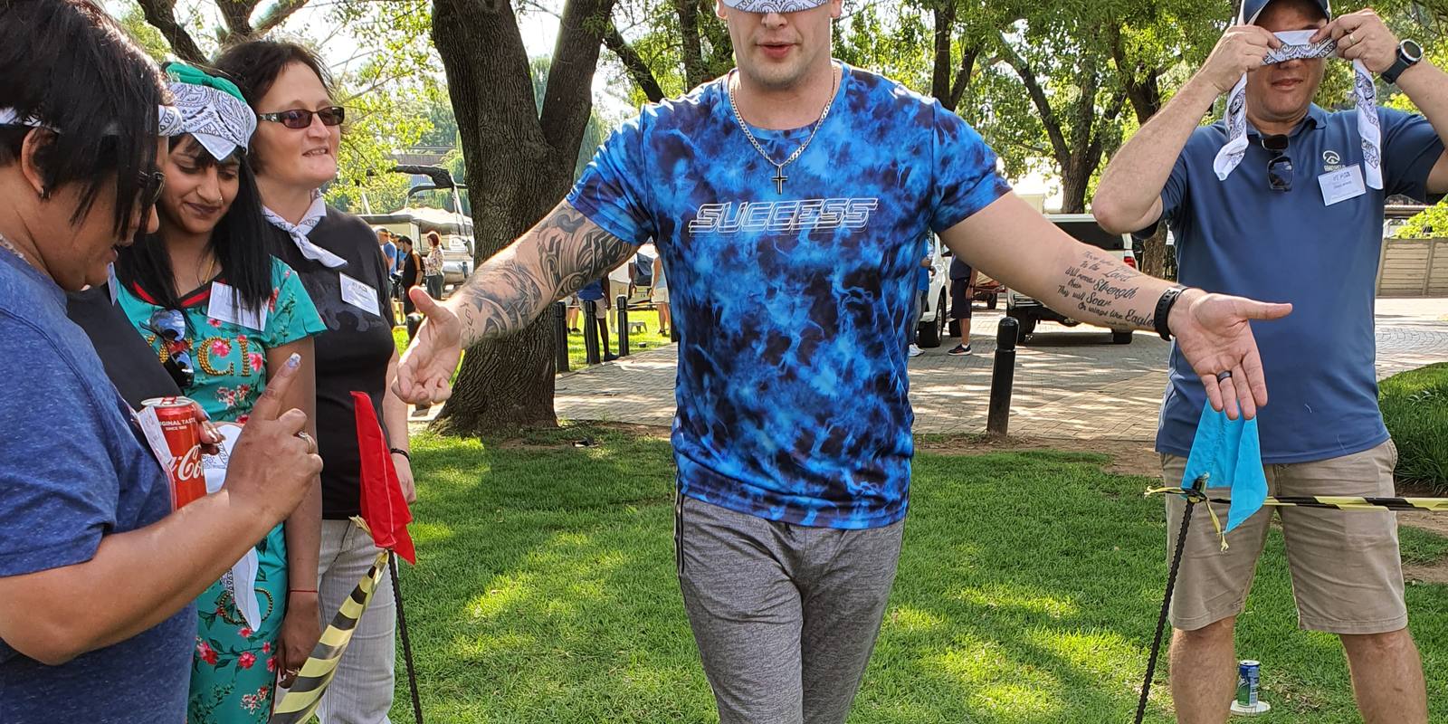 A blindfolded team member walking forward, guided only by his colleagues' instructions